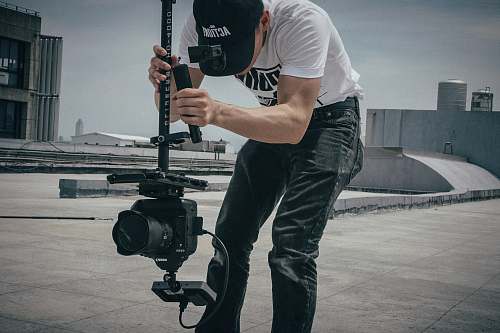 human person holding black camera person
