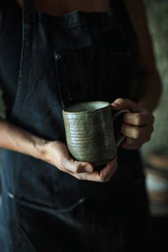 human person holding ceramic mug person