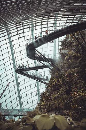 person person inside a glass dome on a huge mound with stairs human
