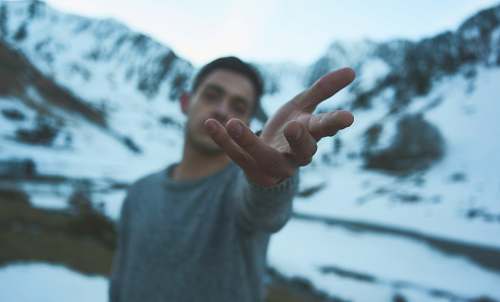person person on snow covered mountain during daytime human