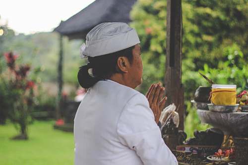 human person praying in front of table person
