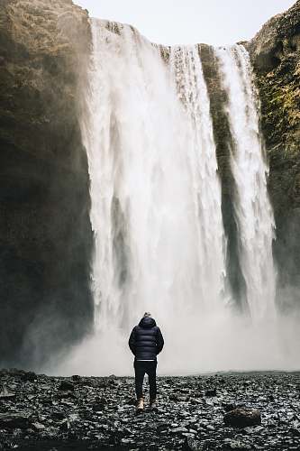 human person standing near at the falls person