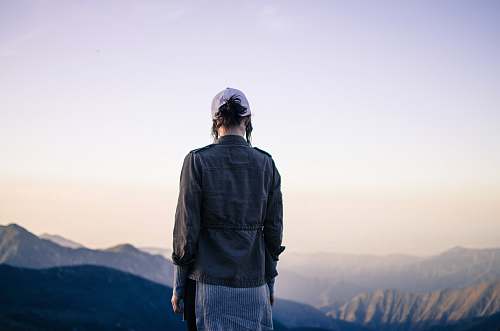person person standing near mountain during daytime human