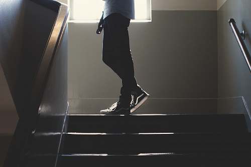 person person standing on in a dim-lit stair human