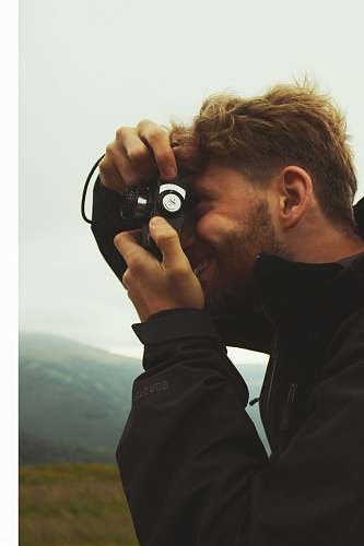 human person using black camera person