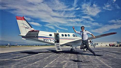 human pilot jumping near aircraft person