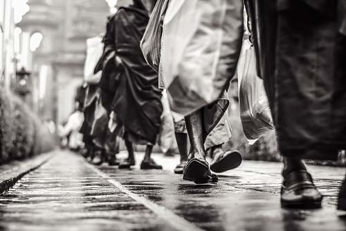 human selective focus graysclae photography of people walking on street person