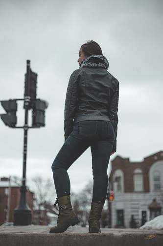 human selective focus photo of woman standing on roadway grey