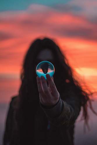 human selective focus photography of woman holding ball person