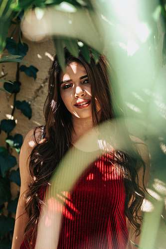 human selective focus photography of woman wearing red camisole person