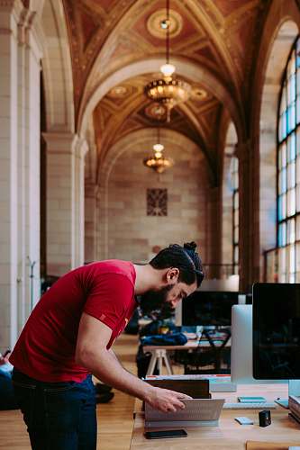 person shallow focus photogoraphy of man looking down to his book monitor