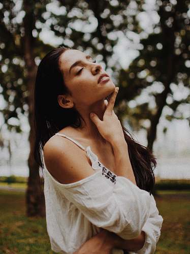 human shallow focus photography on woman in white cold-shoulder top woman