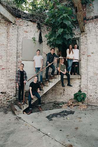 human six men and a woman standing on stair white taking picture person