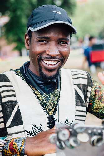 human smiling man wearing black Nike baseball cap person