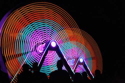 human time lapse photography of people gathering infront of ferris wheel person