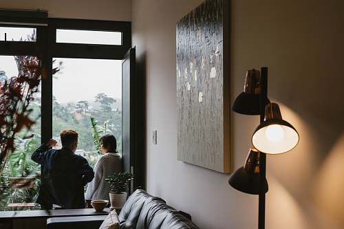 person turned-on 3-head lamp near woman and man sitting on terrace human