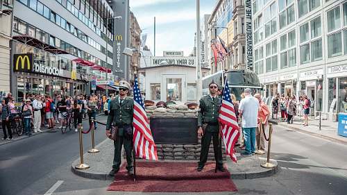 human two men holding USA flags outdoors person