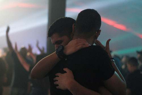 human two men hugging each other inside bar person