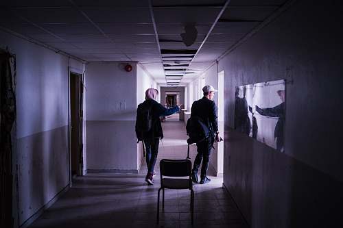 corridor two men walking on corridor chair