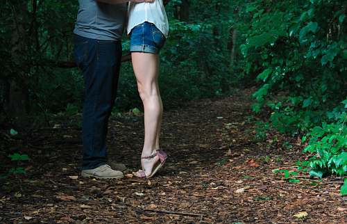 couple two person facing each other surround by trees woods