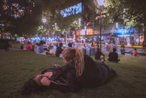 human two woman lying on the grass person
