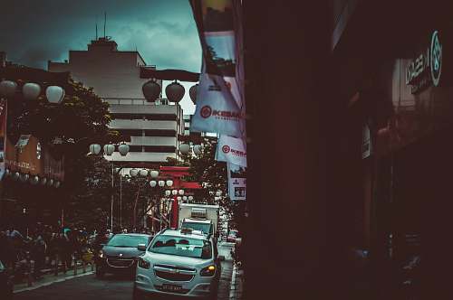 human white Chevrolet vehicle parked near building during nighttime person