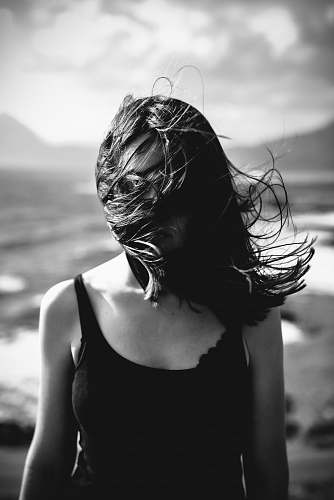 human woman blowing her hair black-and-white