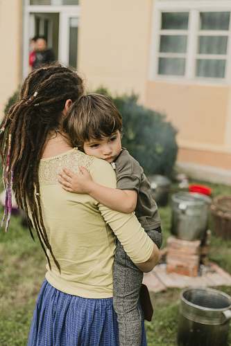human woman carrying boy during daytime person