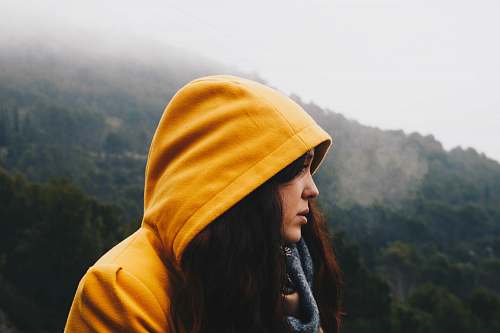 yellow woman facing cliff portrait