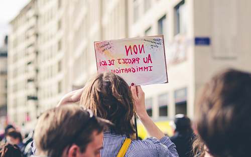 human woman holding card crowd