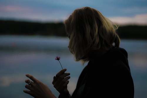 human woman holding flower hand