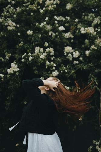 person woman holding her hair near bougainvillea plant human