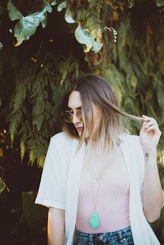 human woman holding her hair while looking sideways person