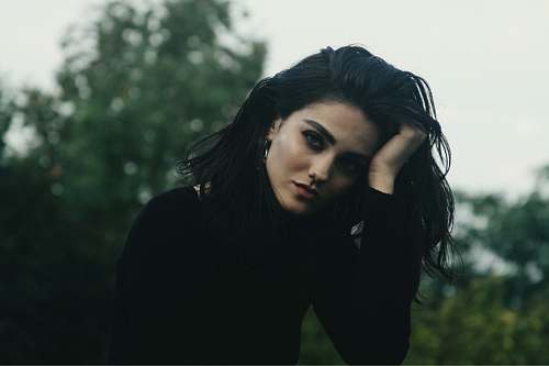 human woman holding her head with her right hand person