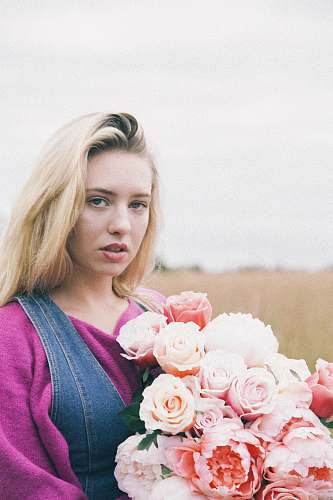 human woman holding pink flower bouquet person
