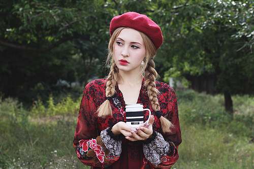 human woman holding white and black mug person