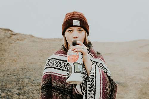human woman holding white and black tumbler person