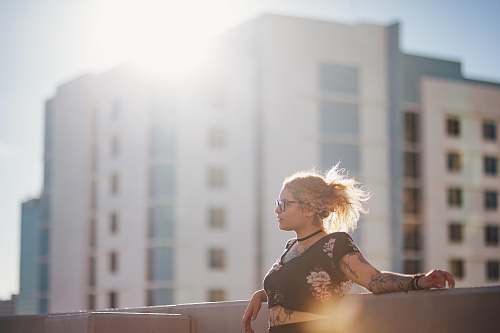 human woman in black floral crop top near building during daytime person