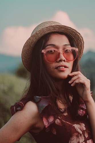 person woman in brown wicker fedora hat posting human