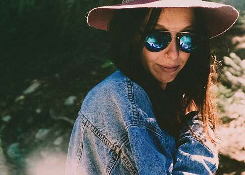 human woman in denim jacket wearing shades person