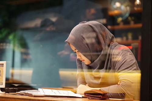human woman in gray traditional dress reading book person