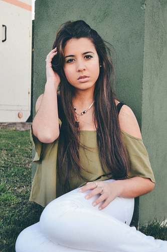 person woman in green off-shoulder top holding her hair pose woman