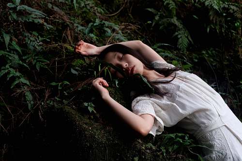 woman woman in white dress lying in white dress forest