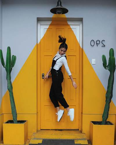 human woman jumping in front of closed door person