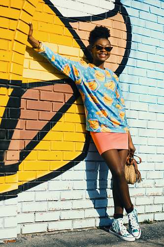person woman leaning on brick wall human