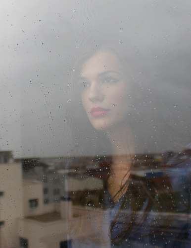 woman woman looking through window window