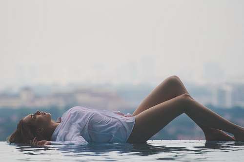 human woman lying on pool during daytime person