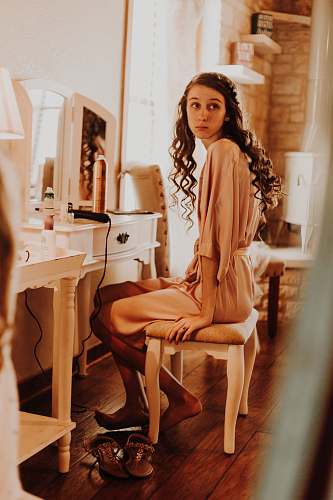 human woman sitting in front of vanity table person