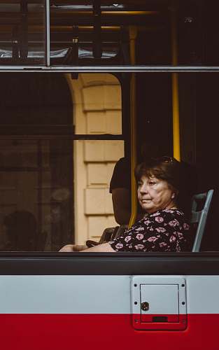 human woman sitting inside a white and red vehicle person