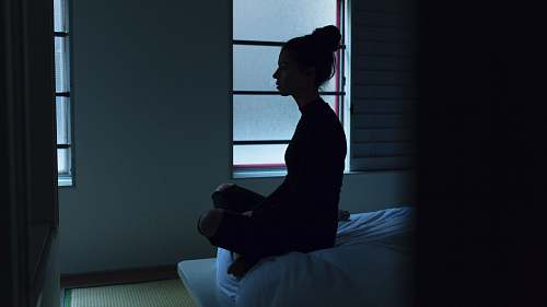 person woman sitting on bed human